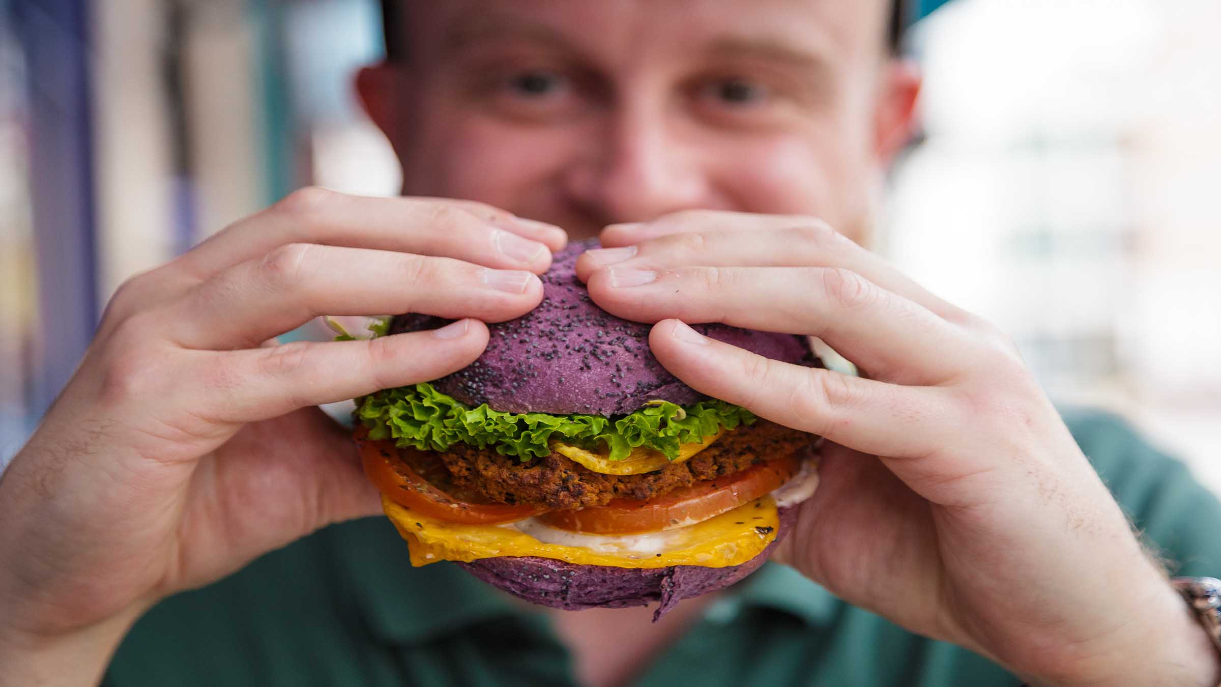 Man eating vegan burger
